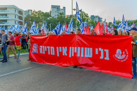 Haifa, Israel - June 10, 2023: People marching with flags and various signs. 23rd week of anti-government protest in Haifa, Israelのeditorial素材