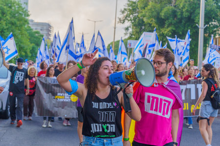 Haifa, Israel - June 10, 2023: People marching with flags and various signs. 23rd week of anti-government protest in Haifa, Israelのeditorial素材