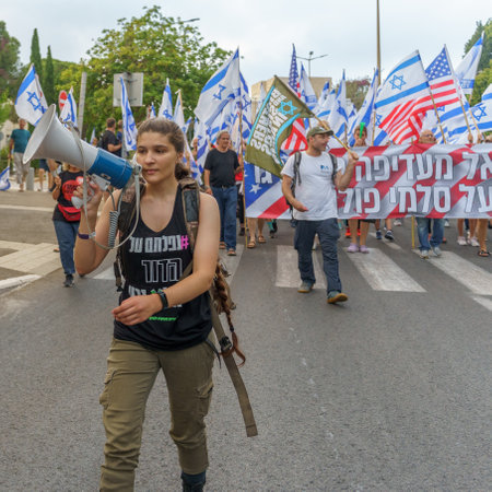 Haifa, Israel - June 17, 2023: People marching with flags and various signs. Week 24 of anti-government protest in Haifa, Israelのeditorial素材