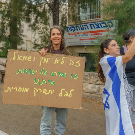 Haifa, Israel - June 17, 2023: People marching with flags and various signs. Week 24 of anti-government protest in Haifa, Israelのeditorial素材