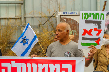Haifa, Israel - June 17, 2023: Group of people with anti-occupation signs. Week 24 of anti-government protest in Haifa, Israelのeditorial素材