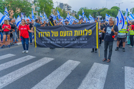 Haifa, Israel - June 17, 2023: People marching with flags and various signs. Week 24 of anti-government protest in Haifa, Israelのeditorial素材