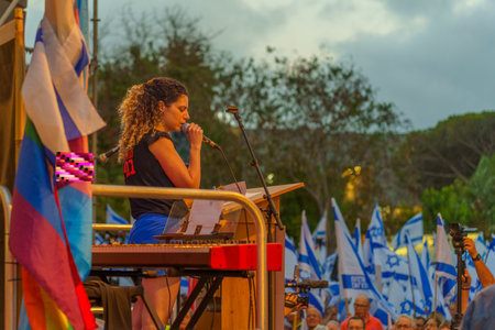 Haifa, Israel - June 17, 2023: Protest leader Rotem Perelman - Farhi speaks to the crowd in a protest against the plans of the new government, claiming its anti-democratic, in Haifa, Israelのeditorial素材