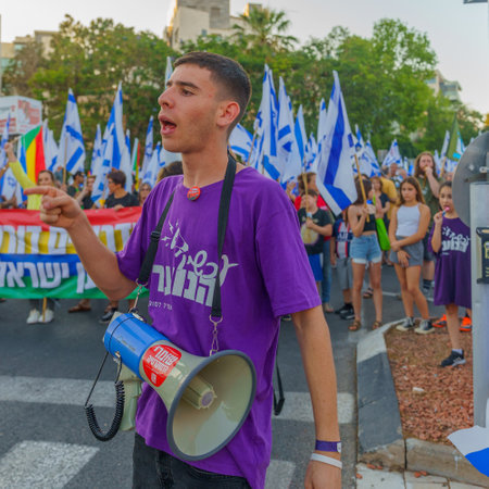 Haifa, Israel - June 24, 2023: People marching with flags and various signs. Week 25 of anti-government protest in Haifa, Israelのeditorial素材