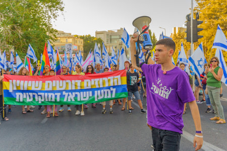 Haifa, Israel - June 24, 2023: People marching with flags and various signs. Week 25 of anti-government protest in Haifa, Israelのeditorial素材
