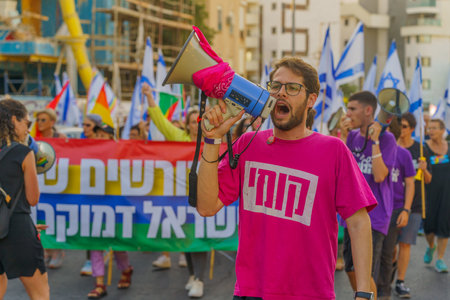 Haifa, Israel - June 24, 2023: People marching with flags and various signs. Week 25 of anti-government protest in Haifa, Israelのeditorial素材