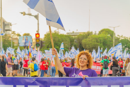 Haifa, Israel - June 24, 2023: People marching with flags and various signs. Week 25 of anti-government protest in Haifa, Israelのeditorial素材