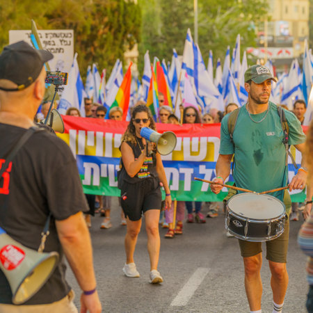 Haifa, Israel - June 24, 2023: People marching with flags and various signs. Week 25 of anti-government protest in Haifa, Israelのeditorial素材