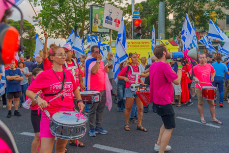Haifa, Israel - July 01, 2023: People marching with drums, flags, and various signs. Week 26 of anti-government protest in Haifa, Israelのeditorial素材