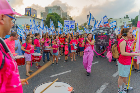 Haifa, Israel - July 01, 2023: People marching with drums, flags, and various signs. Week 26 of anti-government protest in Haifa, Israelのeditorial素材