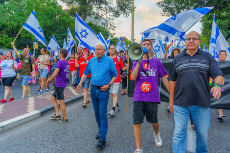 Haifa, Israel - July 01, 2023: People marching with flags and various signs. Week 26 of anti-government protest in Haifa, Israelのeditorial素材