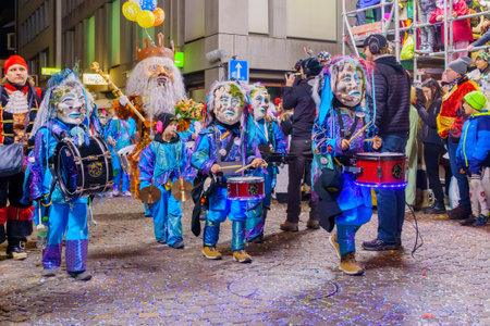 Lucerne, Switzerland - February 21, 2023: Band of musicians in costumes march in the streets, part of the final night parade of the Fasnacht Carnival, in Lucerne (Luzern), Switzerlandのeditorial素材