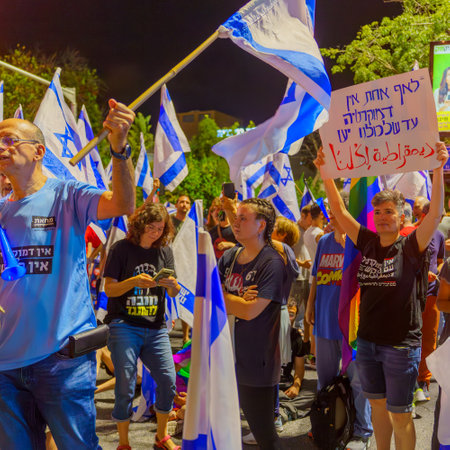 Haifa, Israel - July 05, 2023: People protesting with flags, and various signs, in response to recent legislative action of the government. Haifa, Israelのeditorial素材