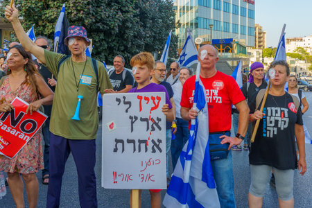 Haifa, Israel - July 08, 2023: People perform anti police brutality display following eye injury of a protesters. Week 27 of anti-government protest in Haifa, Israelのeditorial素材