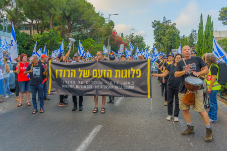 Haifa, Israel - July 08, 2023: People marching with flags and various signs. Week 27 of anti-government protest in Haifa, Israelのeditorial素材