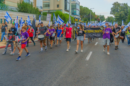 Haifa, Israel - July 08, 2023: People marching with flags and various signs. Week 27 of anti-government protest in Haifa, Israelのeditorial素材