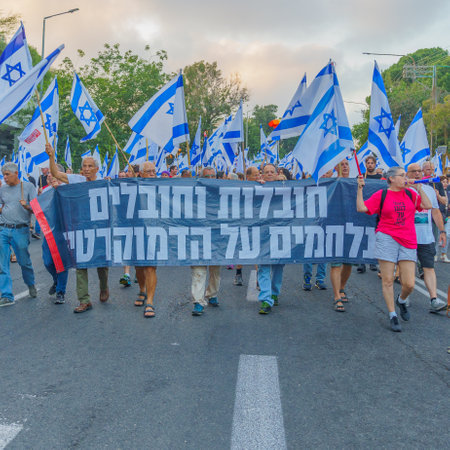 Haifa, Israel - July 08, 2023: People marching with flags and various signs. Week 27 of anti-government protest in Haifa, Israelのeditorial素材
