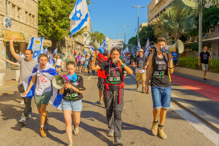 Haifa, Israel - July 11, 2023: People protest with flags and various signs. Part of day of disruption against controversial judicial overhaul, in Haifa, Israelのeditorial素材