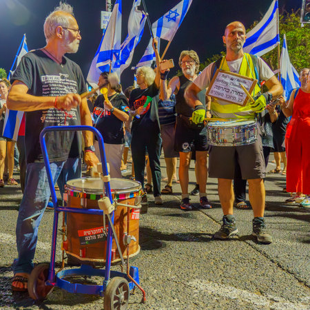 Haifa, Israel - July 11, 2023: People protest with flags and various signs. Part of day of disruption against controversial judicial overhaul, in Haifa, Israelのeditorial素材