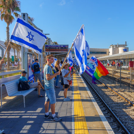 Haifa, Israel - July 18, 2023: People protest with flags and various signs in a train station. Part of day of disruption against controversial judicial overhaul, in Haifa, Israelのeditorial素材