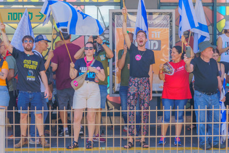 Haifa, Israel - July 18, 2023: People protest with flags and various signs in a train station. Part of day of disruption against controversial judicial overhaul, in Haifa, Israelのeditorial素材