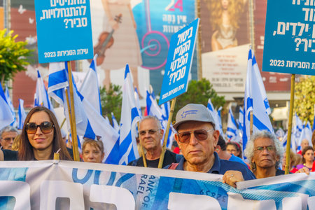 Haifa, Israel - July 22, 2023: People march with flags and various signs. Part of week 29 of protest...
