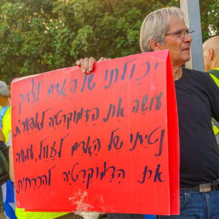 Haifa, Israel - July 22, 2023: People protest with flags and various signs. Part of week 29 of protest against controversial judicial overhaul. Haifa, Israelのeditorial素材