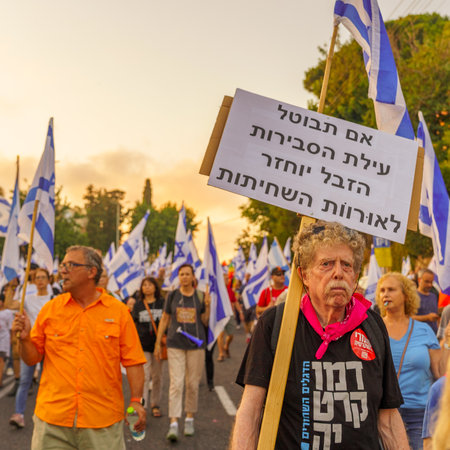 Haifa, Israel - July 22, 2023: People march with flags and various signs. Part of week 29 of protest against controversial judicial overhaul. Haifa, Israelのeditorial素材