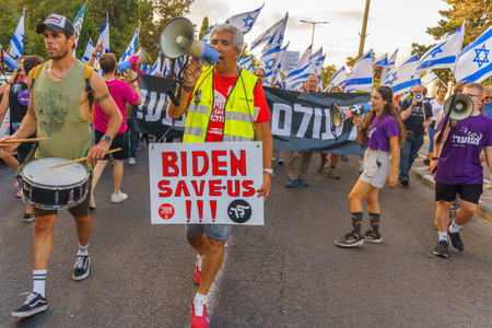 Haifa, Israel - July 29, 2023: People march with various signs under the slogan: we shall never surrender. Part of week 30 of protest against controversial judicial overhaul. Haifa, Israelのeditorial素材