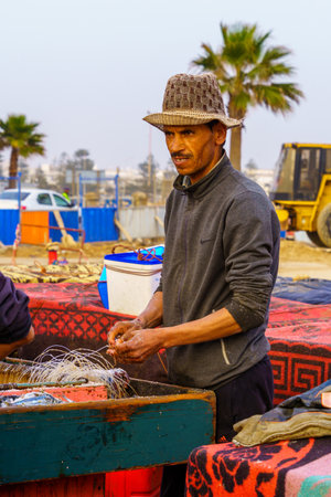 Essaouira, Morocco - April 06, 2023: Scene of the fishing port, with fishermen at work, in Essaouira (Mogador), Moroccoのeditorial素材