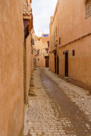 View of an alley with typical red buildings, in the Medina of Marrakesh, Moroccoの写真素材