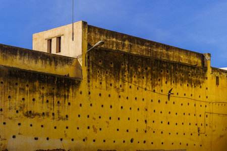 View of old buildings with holes in the walls, the old Medina of Fes, Moroccoの写真素材