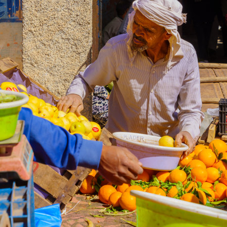 Rissani, Morocco - April 02, 2023: Market scene, with vegetable stalls, sellers, and shoppers, in Rissani, Sahara Desert, Moroccoのeditorial素材
