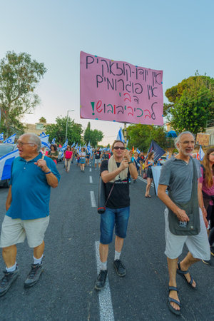 Haifa, Israel - August 05, 2023: People march with anti-occupation signs. Part of week 31 of protest against controversial judicial overhaul. Haifa, Israelのeditorial素材