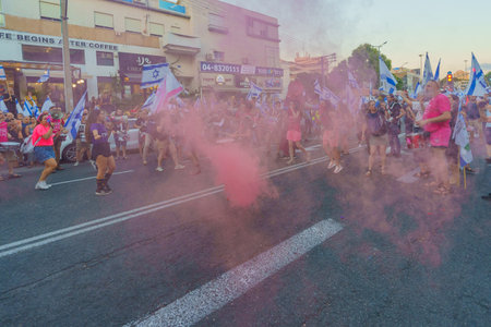 Haifa, Israel - August 05, 2023: People march with various flags and signs, slogan: We shall not give up on a better future. Week 31 of protest against controversial judicial overhaul. Haifa, Israelのeditorial素材