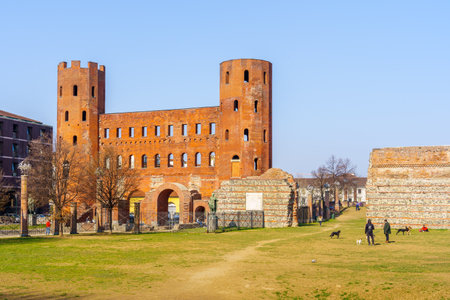Turin, Italy - February 25, 2022: View of the Palatine Gate and park, with locals and visitors, in Turin, Piedmont, Northern Italyのeditorial素材