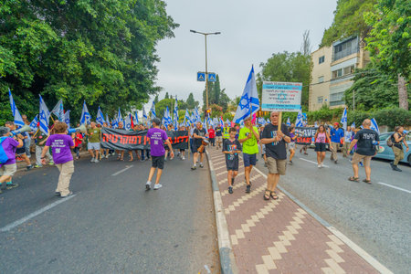 Haifa, Israel - August 12, 2023: People march with various flags and signs. Week 32 of protest against controversial judicial overhaul. Haifa, Israelのeditorial素材