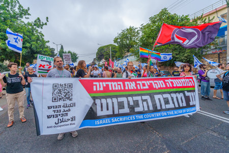Haifa, Israel - August 12, 2023: People march with anti-occupation signs. Part of week 32 of protest against controversial judicial overhaul. Haifa, Israelのeditorial素材