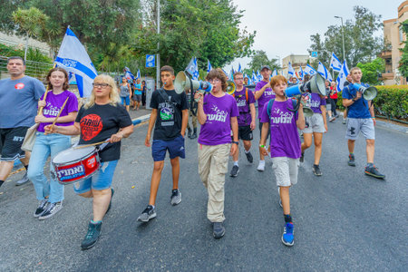 Haifa, Israel - August 12, 2023: People march with various flags and signs. Week 32 of protest against controversial judicial overhaul. Haifa, Israelのeditorial素材