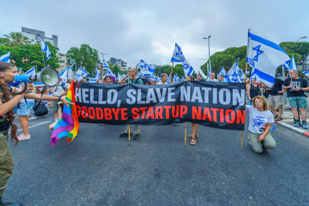 Haifa, Israel - August 12, 2023: People march with various flags and signs. Week 32 of protest against controversial judicial overhaul. Haifa, Israelのeditorial素材