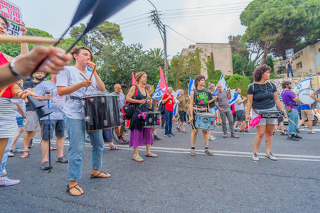 Haifa, Israel - August 12, 2023: Group of young drummers take part in protest. Part of week 32 of protest against controversial judicial overhaul. Haifa, Israelのeditorial素材