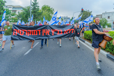 Haifa, Israel - August 12, 2023: People march with various flags and signs. Week 32 of protest against controversial judicial overhaul. Haifa, Israelのeditorial素材