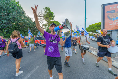 Haifa, Israel - August 12, 2023: People march with various flags and signs. Week 32 of protest against controversial judicial overhaul. Haifa, Israelのeditorial素材