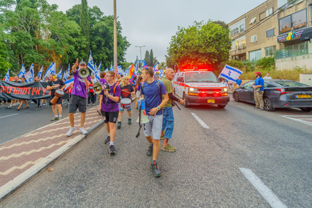 Haifa, Israel - August 12, 2023: Protesters let an ambulance through during a march. Week 32 of protest against controversial judicial overhaul. Haifa, Israelのeditorial素材