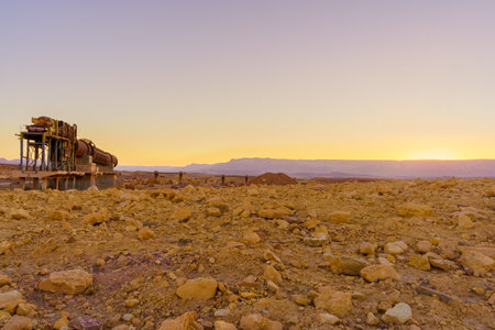 Sunset view of an old quarry and the landscape of Makhtesh (crater) Ramon, in the Negev Desert, Southern Israel. It is a geological landform of a large erosion cirqueの写真素材