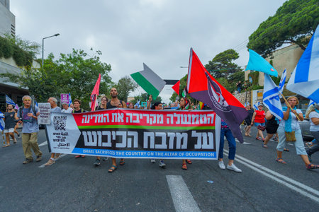 Haifa, Israel - August 19, 2023: People march with anti-occupation banner. Week 33 of protest...