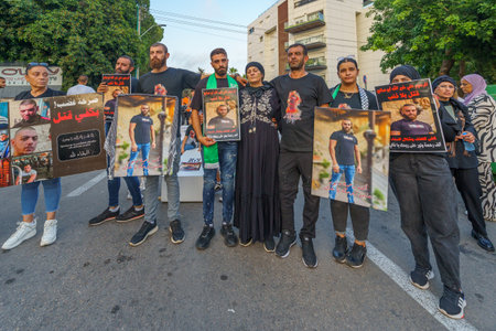 Haifa, Israel - August 31, 2023: People with pictures of their loved ones, part of the march of the...