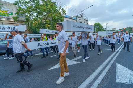 Haifa, Israel - August 31, 2023: People carry symbolic coffins, part of the march of the dead protest against rising violence and murder rate in the Arab society. Haifa, Israelのeditorial素材