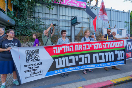 Haifa, Israel - September 02, 2023: People march with anti-occupation banner. Week 35 of protest against controversial judicial overhaul. Haifa, Israelのeditorial素材