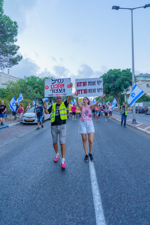 Haifa, Israel - September 02, 2023: People march with various signs and flags. Week 35 of protest against controversial judicial overhaul. Haifa, Israelのeditorial素材